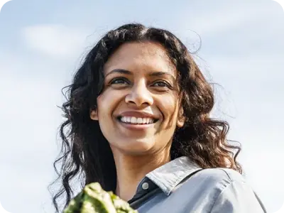 Woman smiling while holding a bag of groceries